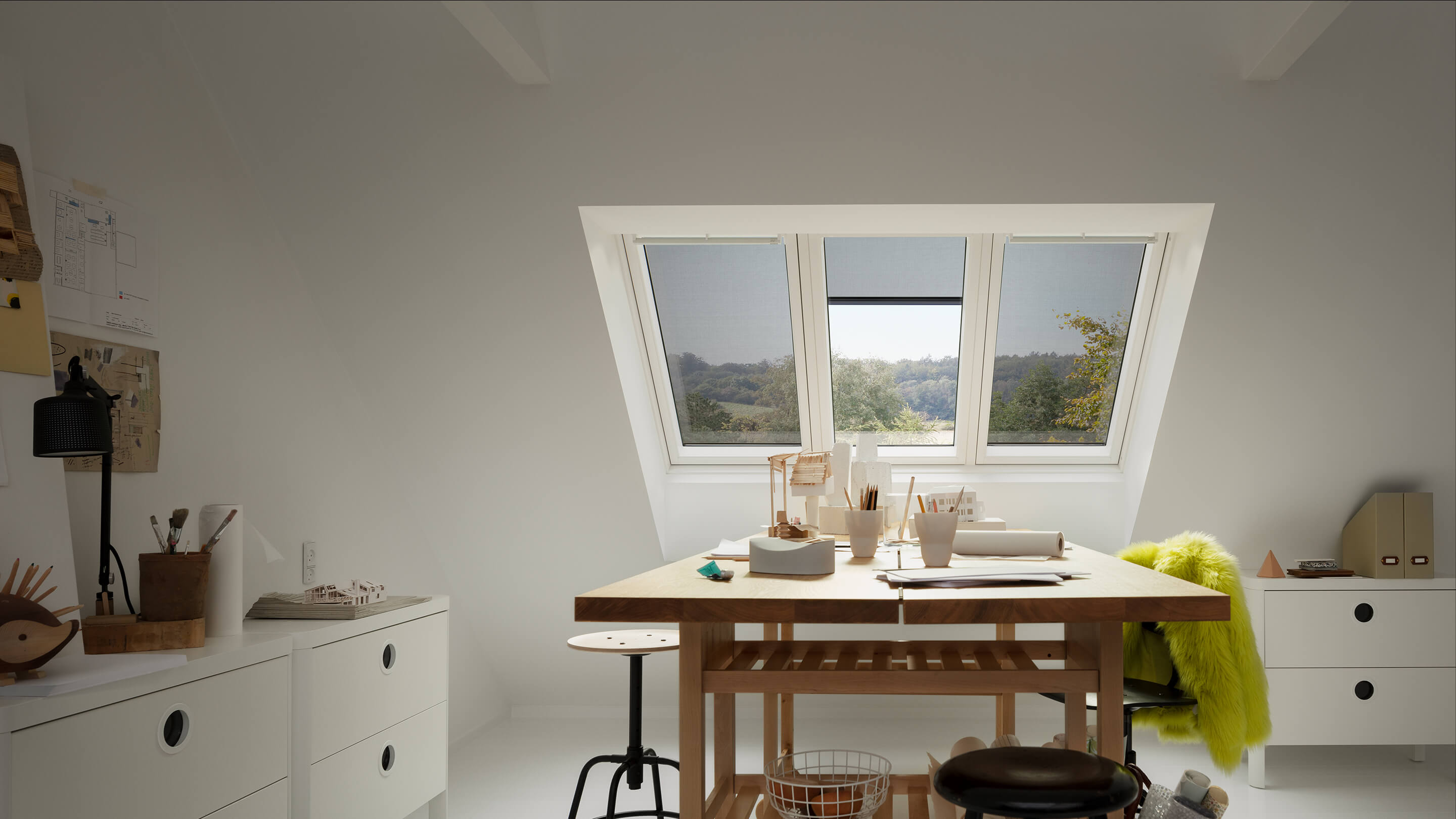 VELUX anti-heat awning blind installed in three VELUX roof windows seen from the inside