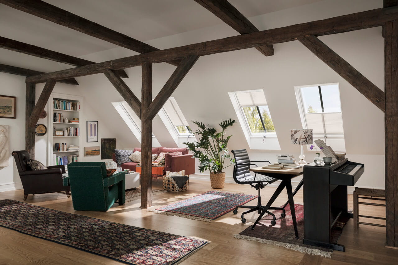 An old attic with place for living room and home office with roof windows