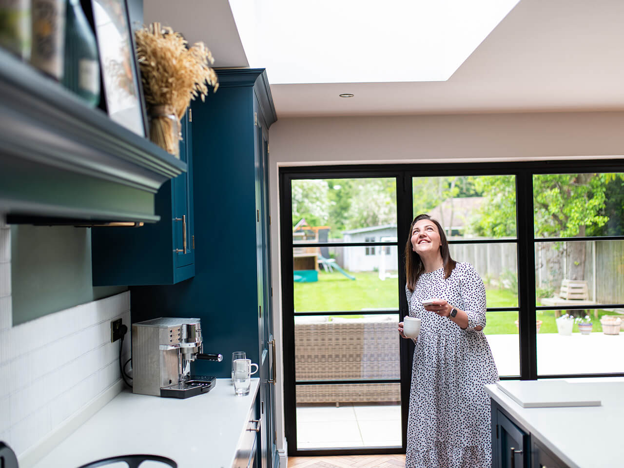 Woman using VELUX intelligent home control to open window